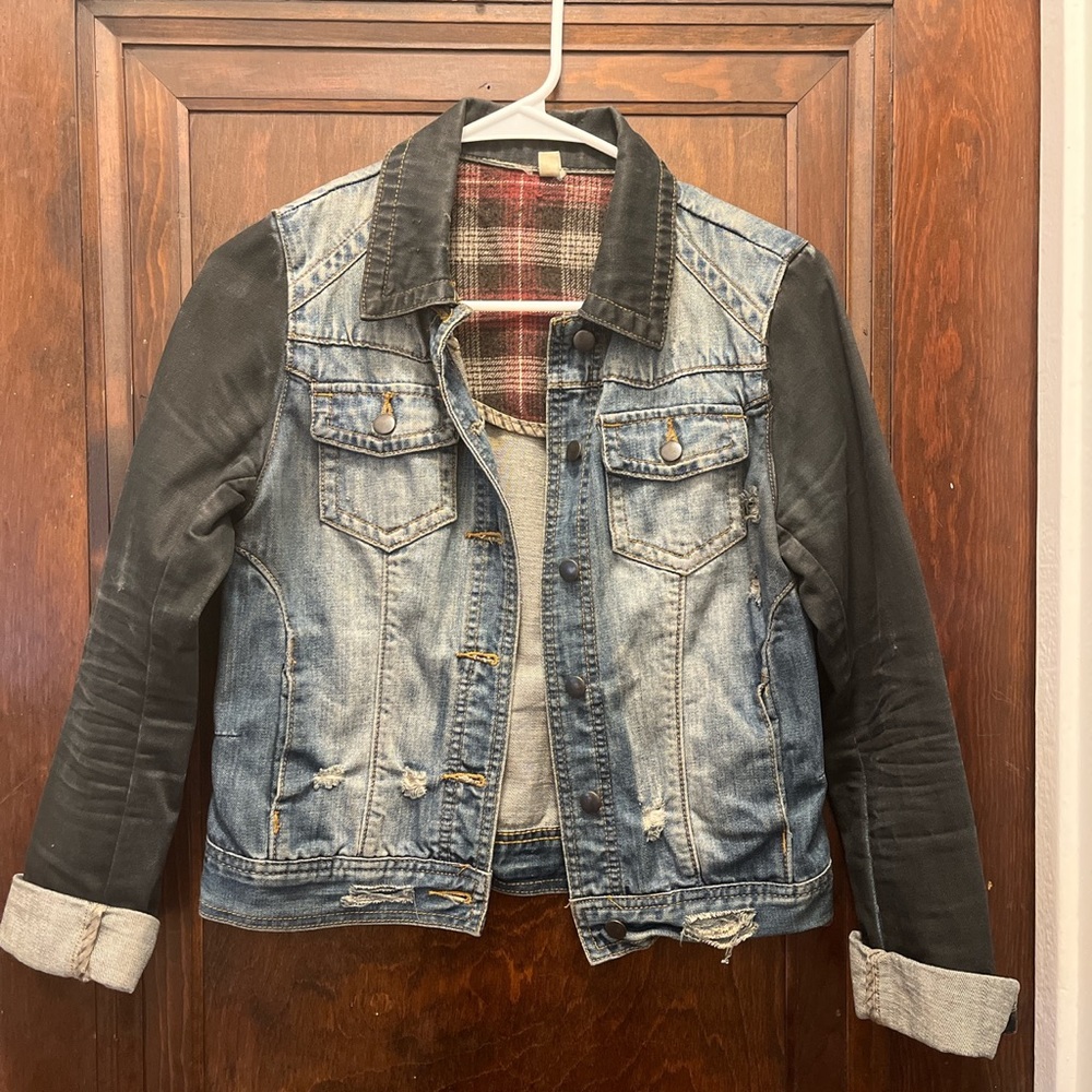 Distressed denim jacket w/ black sleeves